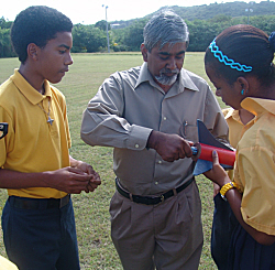 Science teacher Steven Bullock (center) helps rocketry club members Hector Acosta and Luz De Los Santos install the rocket motor. Science teacher Steven Bullock (center) helps rocketry club members Hector Acosta and Luz De Los Santos install the rocket motor.
