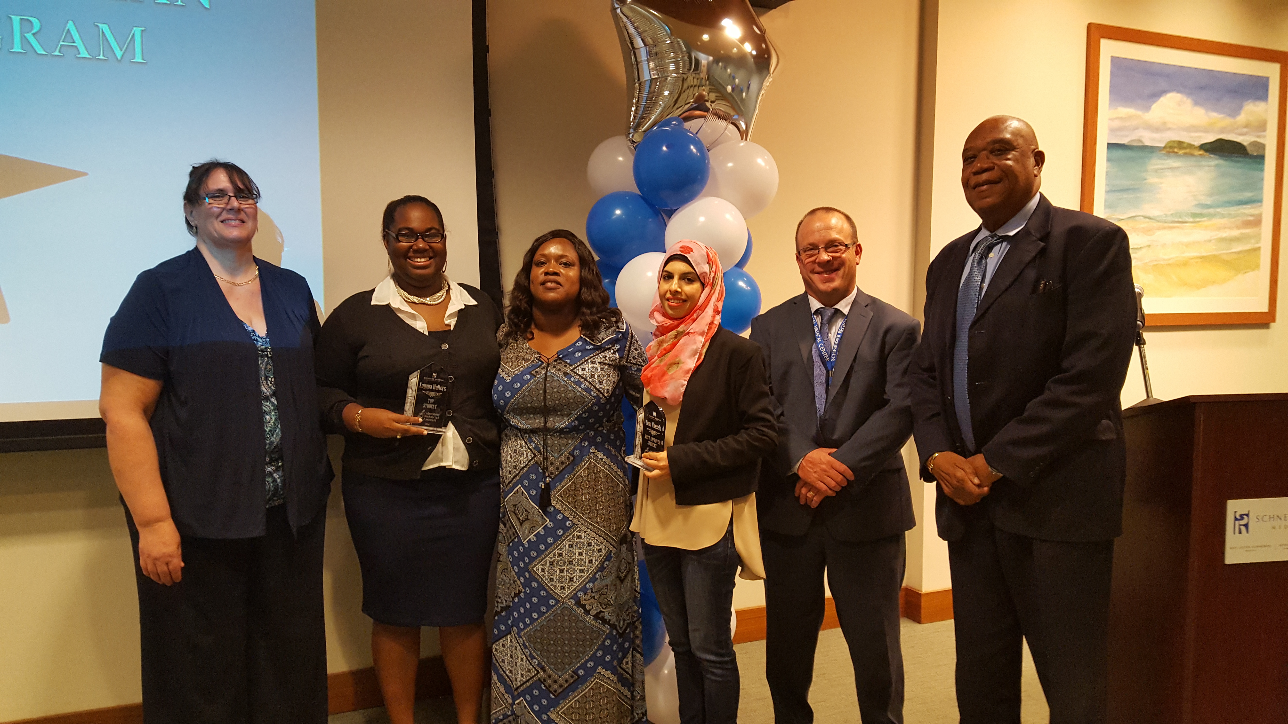 (left to right) Carol Kelly, lead medical technologist at SRMC; Kayana Walters, graduate and valedictorian of class; Mauritza Phillip, clinical laboratory director; Sena Hussein, graduate; Charles Nickerson, SRMC VP of Operations; Bernard Wheatley, SRMC CEO; (not pictured - graduate Amira Plaskett)