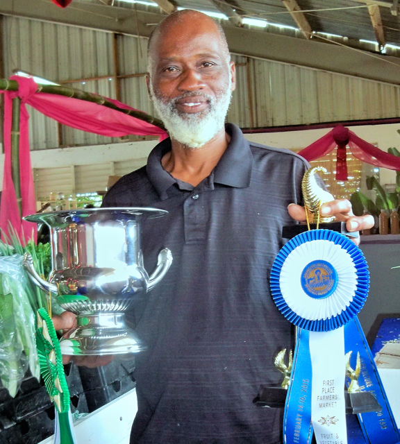 Dale Browne, owner of Sejah Farms holding his trophies from this year's Agrifest.