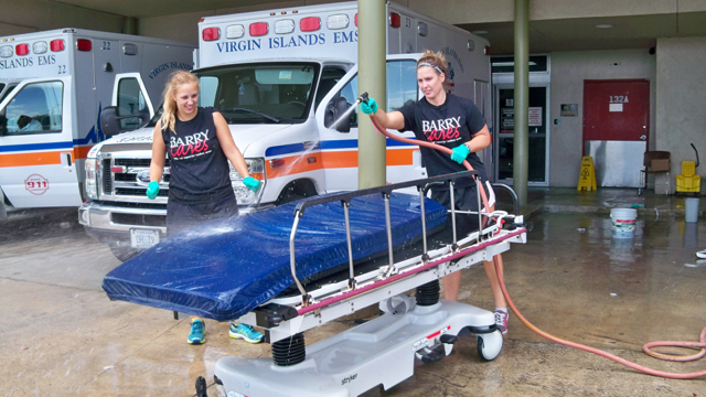 Chelsea Nagle, left, and Drea Blaine wash beds at the Gov. Juan F. Luis Hospital as part of a volunteer cleanup.