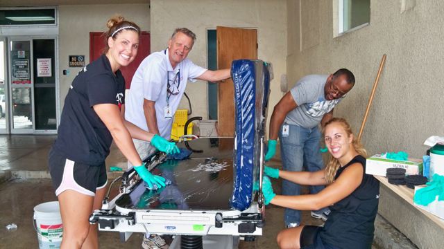 Drea Blaine, left, Mike Funk, Anthony Kiture, and Chelsea Nagle wash beds.