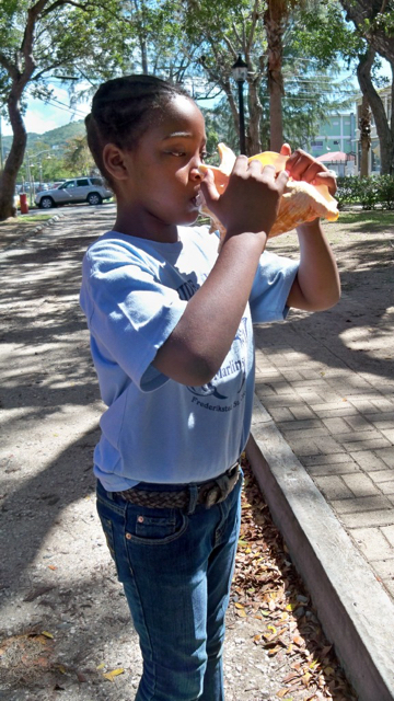 Claude O. Markoe Elementary School student Nyarah McMillan blows a conch during the school's visit in February to the shell exhibit.