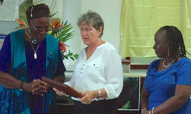 Gloria Joseph accepts a Women For Peace award from Carolyn Keys and Opal Palmer Adisa Sunday.