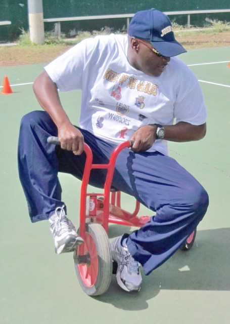 Sen. Novelle Francis shows winning form in the tricycle race. 