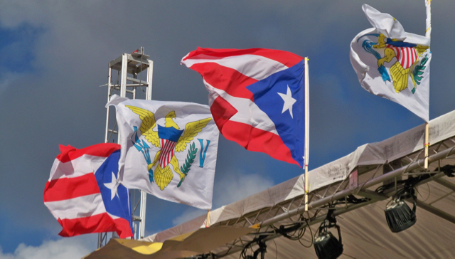 Virgin Islands and Puerto Rican Flags fly over the stage at the David C. Canegata Ball Park.