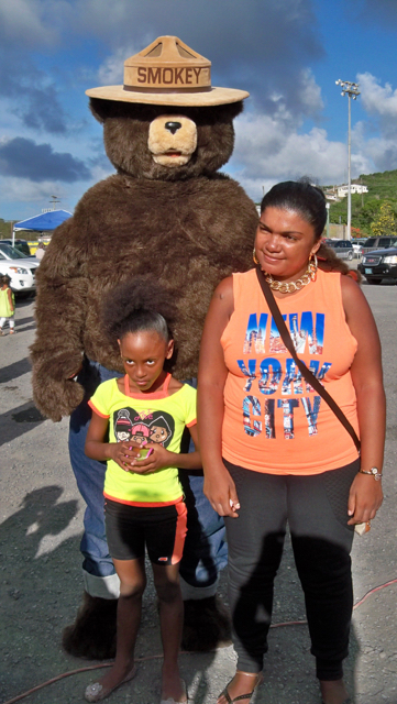 Yvelis Navarro and Iris Navarro pose with Smokey the Bear.