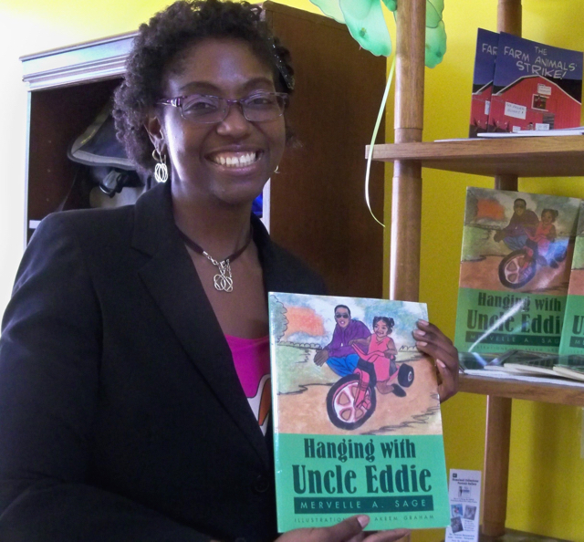Mervelle A.Sage shows her book, 'Hanging with Uncle Eddie.'
