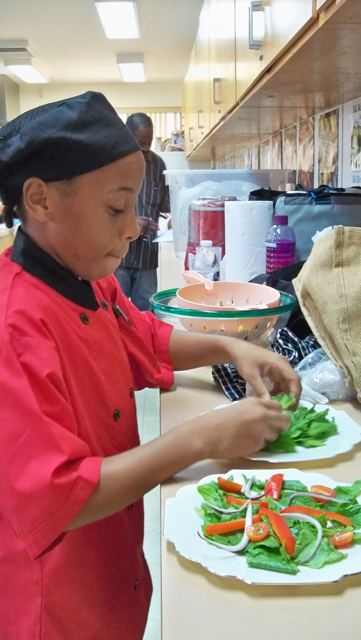 T'Anna Lake, a sixth grader at Free Will Baptist, prepares salad. 