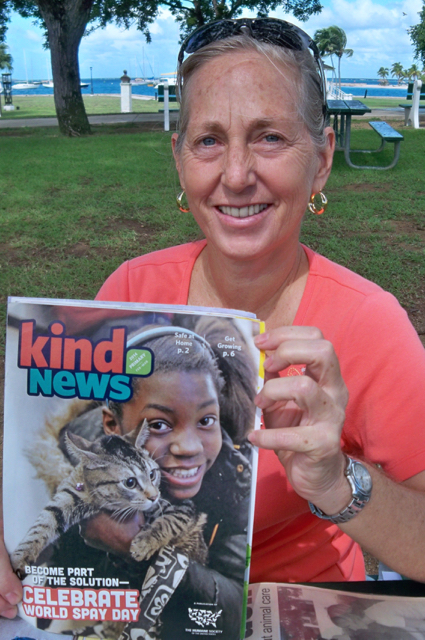 Therese Donarski, temporary shelter coordinator at the Animal Welfare Center, with a copy of 'Kind News' quarterly magazine.