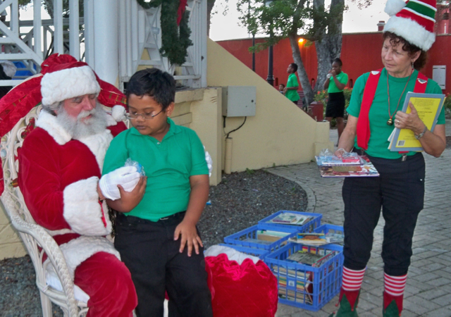 Daniel Lago, 8, meets Santa and elf Ellie Hirsh.
