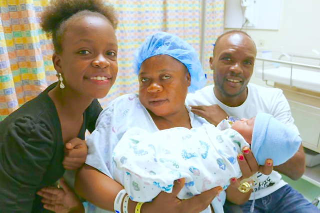 From left, big sister Magdalyn Charles, mom Evelyne Elasme, and dad Stevenson Charles cuddle baby Charlenson, the territory's first baby of 2017.