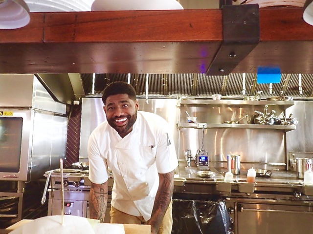 Chef Digby Stridiron looks out from the kitchen of his restaurant, Balter.