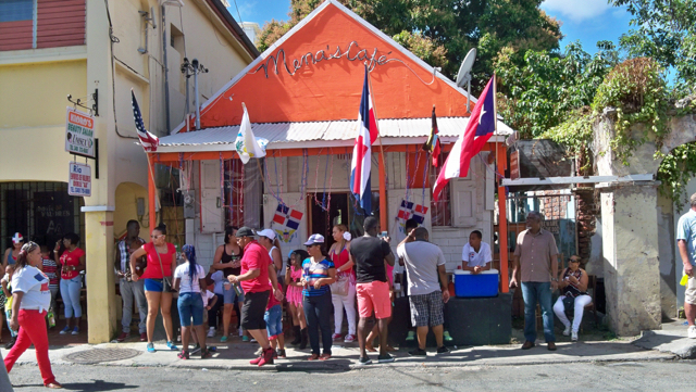 A crowd watches the parade from Mena&rsquo;s Café.