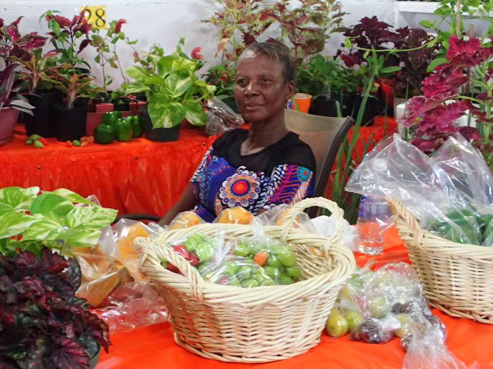 Romelda Jack shows off produce she grew on her quarter-acre plot of land at Sunny Acres.