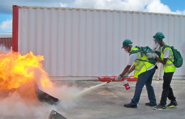 Students put out fires as part of Sunday's mock emergency drill.