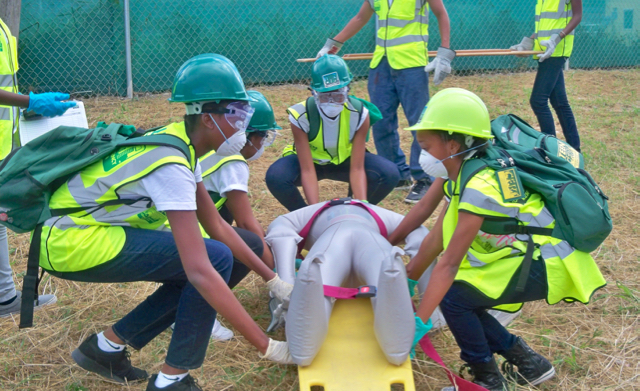 Teen CERT students carry a 'victim' to triage.