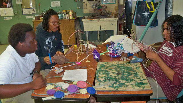 Orrian Browne, left, Jemal Pemberton and Leonardo Alicea work on an art project.