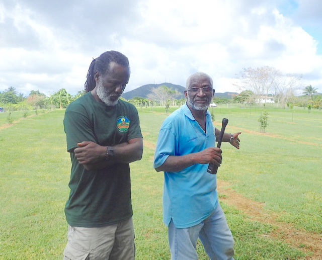 Assistant Ag Commissioner Errol Chichester, left, and farmer Stafford Crossman talk about farming and specialty crops during Saturday's farm tour.