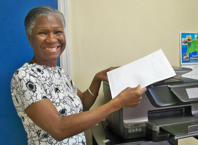 Tina Beazer, interim executive director of the American Cancer Society V.I., makes copies at the ACS office.