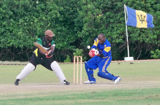 A Nevis batsman defends the wicket against St. Croix in the championship game of the Leeward Islands Masters Cricket 20/20.