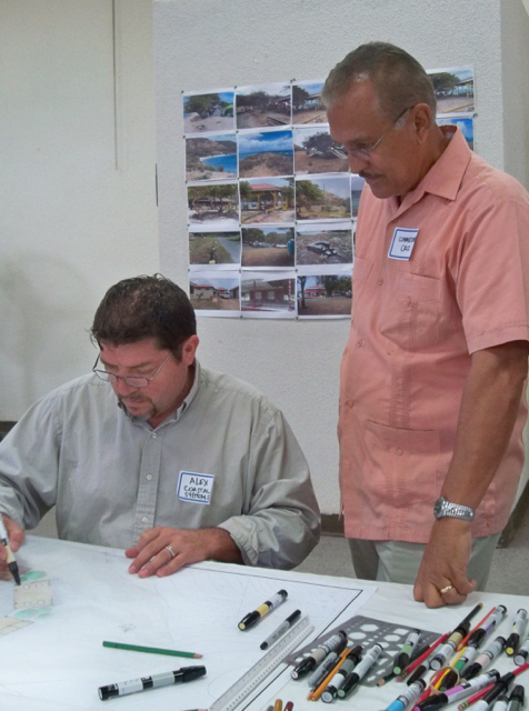 Pedro Cruz, right, commissioner of the Department of Sports, Parks and Recreation, watches Alex Avila, architect for Coastal Systems-USVI, drawing designs.