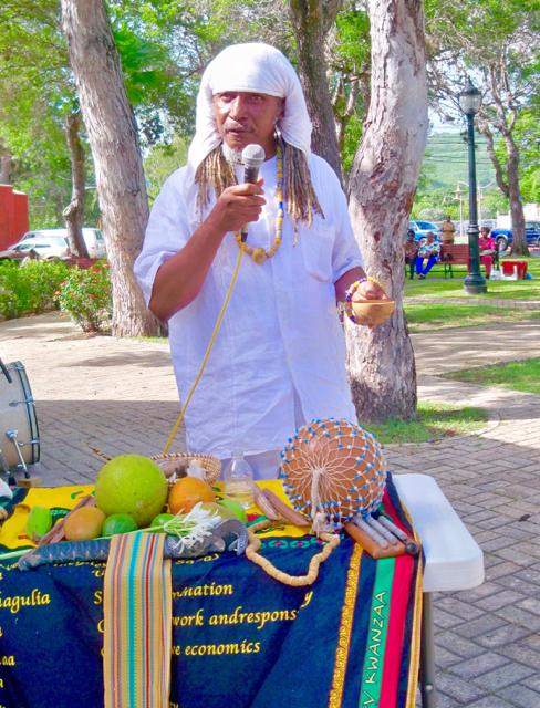 Carl Christopher, from Per Ankh, performs a ceremonial libation at the opening of the Emancipation Day celebration.
