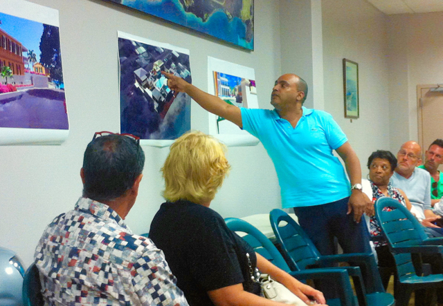 Architect Gerville Larsen points out a detail in the proposed development.