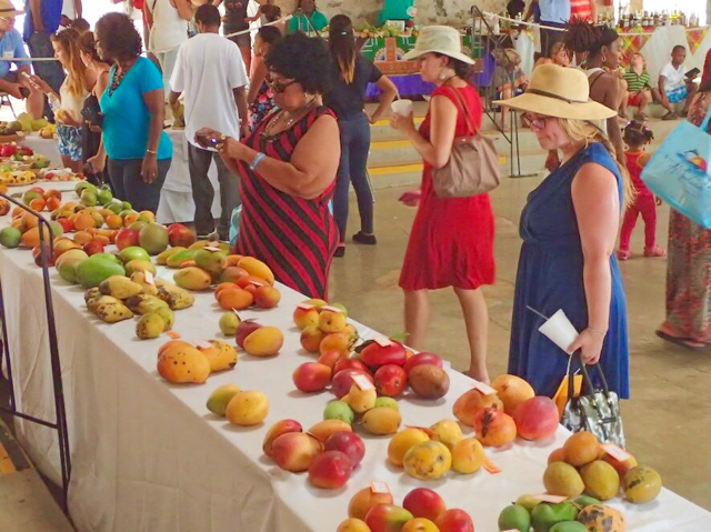 Visitors to Mango Melee peruse the displays of succulent tropical fruit.