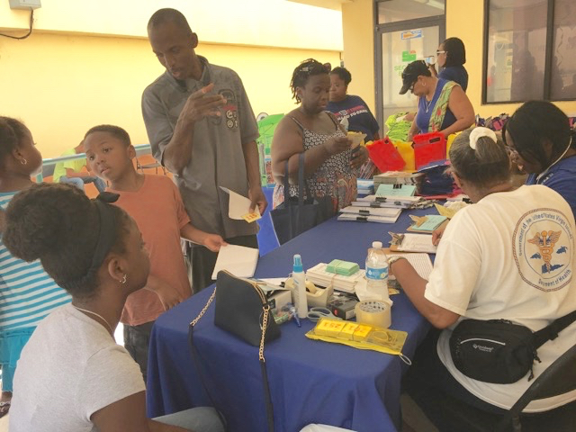 Families sign up their children for the Department of Health's free immunization, back-to-school event Saturday. (Photo submitted by DOH)
