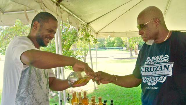 Kareem Francis, left, from the W-Right Apiary, gives samples of mead to Cecil Hodge.
