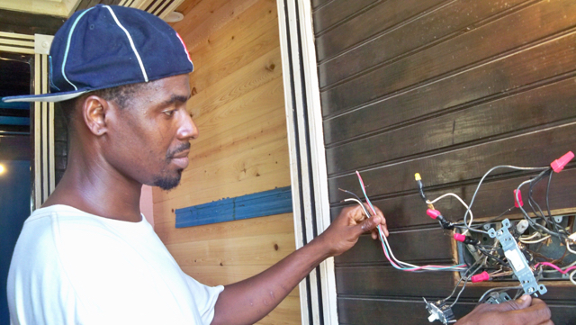 Samuel Cave works on the wiring at The Fred.