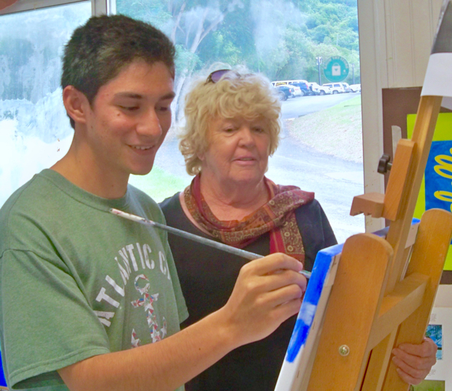 Biddle watches student Mario Capriola work.