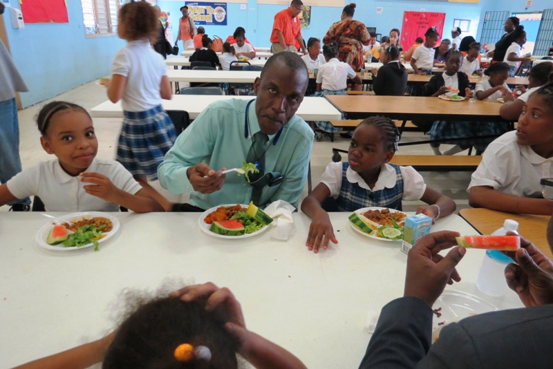 Commissioner Robles eats with some students at Claude O. Markoe School.