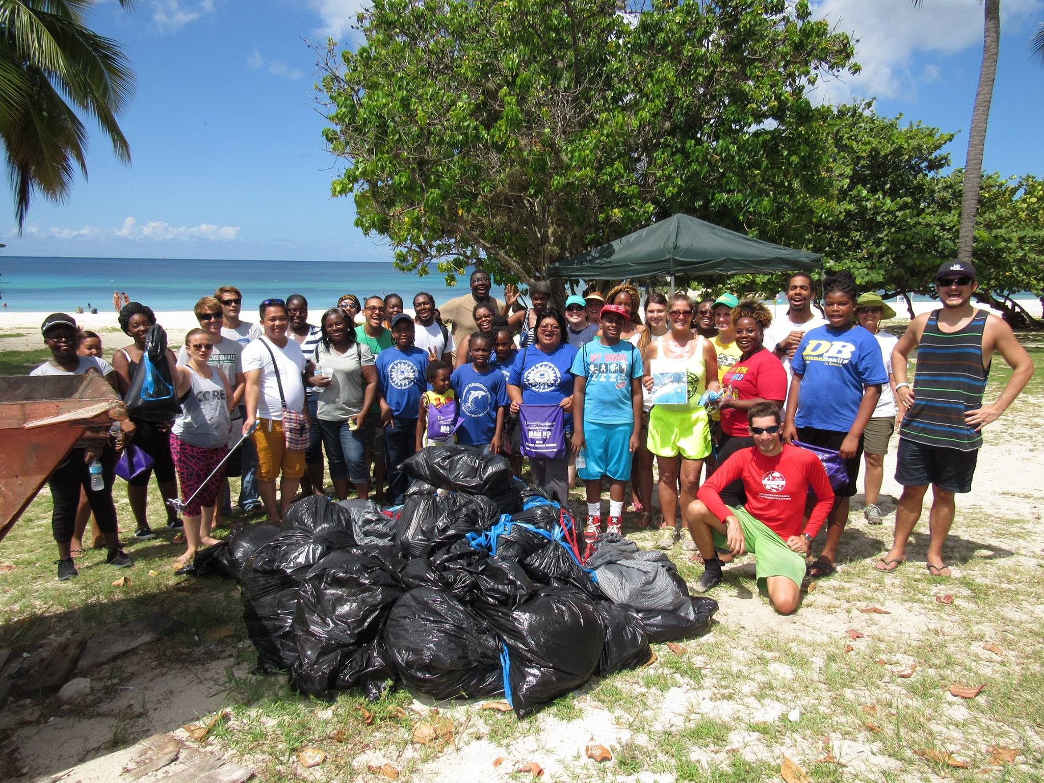Group gathers at the end of Marine Debris Clean-up at Brewers Bay Beach.