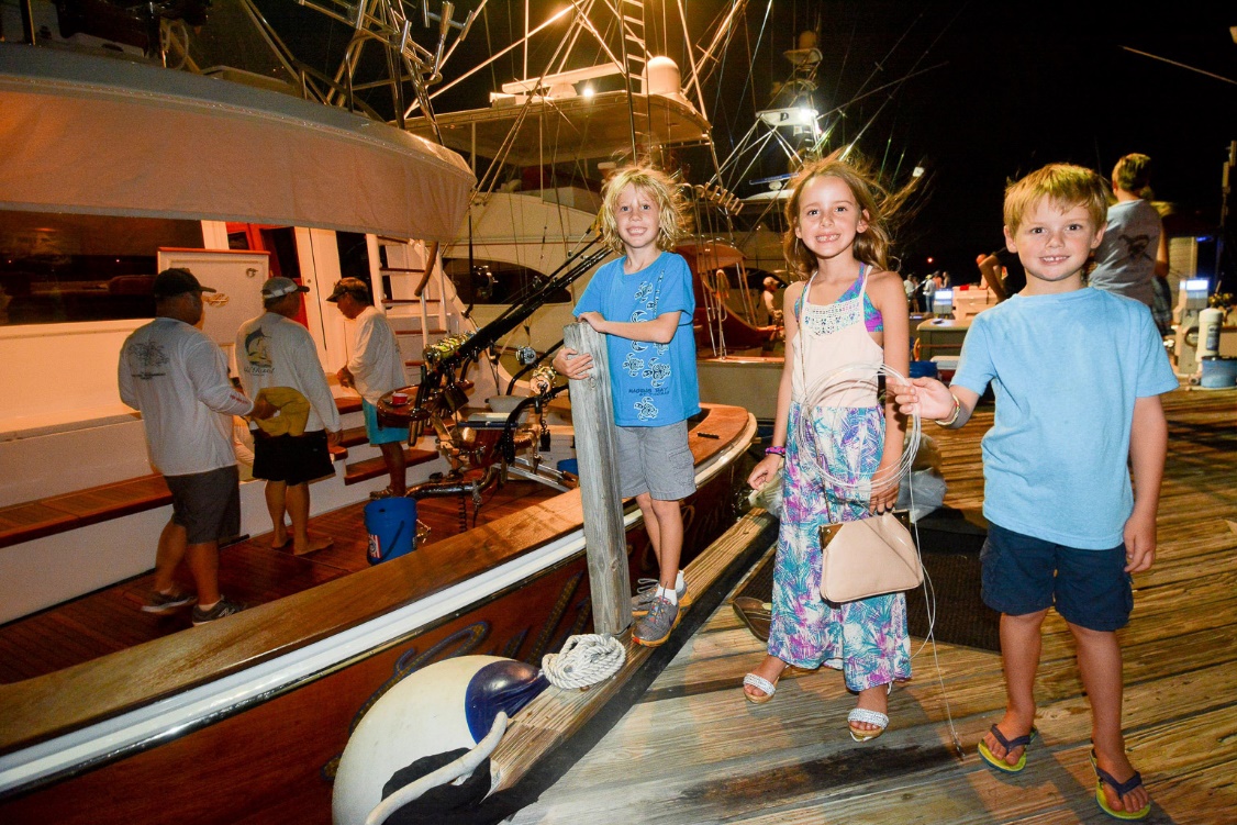 Charlie Gerritsen, Macy Barringer and Ben Barringer were among the crowds on the dock watching the Gulf Rascal back into the dock after a day of tournament fishing. (Credit - Dean Barnes)