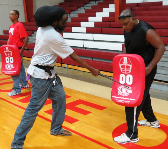 Secondary school monitors learn the proper way to defend themselves using a baton during professional development at the CHS gym. 