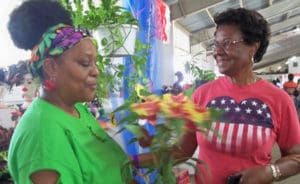 Edna Santiago, left, and Agnes Verhoff discuss coleus at the annual Agrifest.