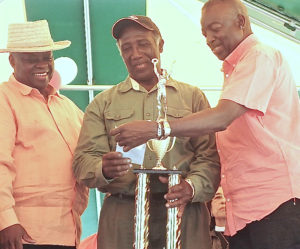 Reuben Liburd, center, the Crop Farmer of the Year, is congratulated by Gov. Kenneth E. Mapp and Lt. Gov. Osbert Potter.