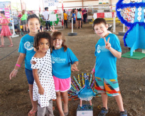 Students from St. Croix Montessori school stand next to the peacock they made out of recycled and repurposed items.