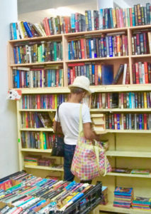 A patron browses the shelves at AWC.