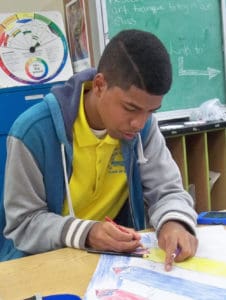 Moises Carmona puts the finishing touches on his flag.