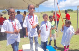 Brianna Isaac, Ameka Heywood and Roberto Marrero receive gold, silver and bronze medals for winning the 50-meter dash.