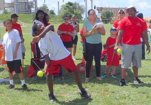Teammates and volunteers cheer as Angelo Mattis prepares to toss the softball at the 40th Special Olympics on St. Croix.