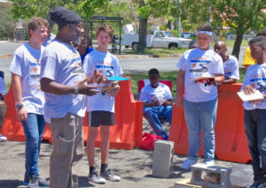 Carl Joseph, Energy Office staff member, gives students last minute instructions before the start of a heat.