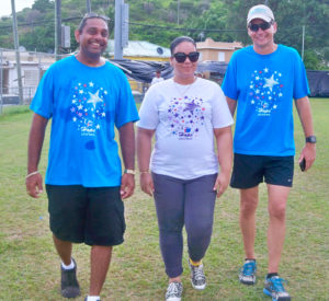 Rollin Allahar, left, Jamillie Perez and Jay Gleason take part in the Relay for Life at the D.C. Canegata Ballpark.