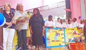 EarlyAct instructors Liz Goggins and Sandra Gerard-Leung are presented crowns and flowers by Gardine Vice Principal Anna Gordon and members of the club. 