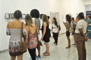 Exhibition goers enjoy works by V.I. contemporary artists.