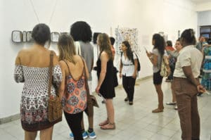 Exhibition goers enjoy works by V.I. contemporary artists.