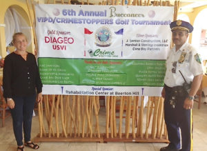 Laurie Dunton of Crime Soppers USVI and Deputy Chief Mark Corneiro at the Buccaneer Hotel VIPD-Crimestoppers golf tournament. (Photo submitted by the VIPD)