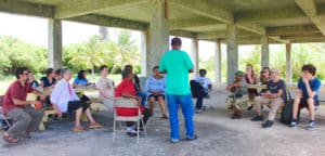 Students and professors speaking with former residents of Estate Bethlehem who lived there until the factory closed in 1966.  This meeting is across the street from the armory, in the property leased by the St. Croix Farmers in Action. (Photo by Lindsay Wooleyhand)